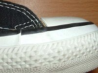 Early 1990s Black High Top Chucks  Close up of the outer stitching on the right side of a right early 1990s black high top.