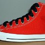 2-Tone Chucks  Left red and black 2-tone high top with wide black laces, outside view.