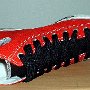 2-Tone Chucks  Right red and black 2-tone high top with wide black lace, sideways top view.