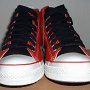 2-Tone Chucks  Red and black 2-tone high tops, new with tag and black wide laces, front view.