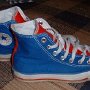 2-Tone Chucks  Royal blue and red 2-tone high tops, side view.