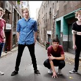 5 Seconds of Summer  Picture of the band in a narrow street.