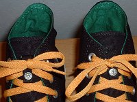 Black/Green/Amber Foldover High Top Chucks  Closeup of the lace snap with a tied bow on black, green, amber foldovers.