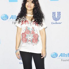 Alessia Cara  Alessia Cara wearing blue high top chucks on the blue carpet.