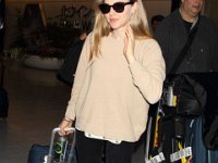 Amanda Seyfried  Arriving at the airport in charcoal grey low top chucks.