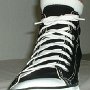 New Black High Top Chucks  Wearing a new right black high top, front view.