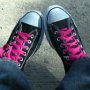 New Black High Top Chucks  Sitting in new black high tops with neon pink laces, top view.