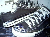 Black Low Cut Oxford Chucks  Deccorated black low cuts, angled side and top views.