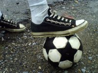Black Low Cut Oxford Chucks  Playing soccer. Note the unusual lacing.
