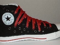 Black and Red Multiple Eyelet High Top Chucks  Inside patch view of a left black and red multiple eyelet high top.