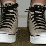 Black Sabbath High Top Chucks  Wearing tan and black print  Black Sabbath high tops with black retro shoelaces, front view 1.