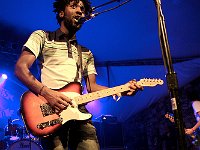 Bloc Party  Lead singer Kele Okereke sports his black high top chucks during a concert.
