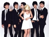 Blondie  Posed photo of the band. Nigel Harrison and Clem Burke are wearing red or black Chuck Taylors.