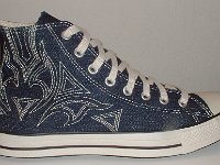 Blue Denim Embroidered High Top Chucks  Outside view of a right blue denim high top with stitched details.
