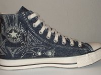 Blue Denim Embroidered High Top Chucks  Inside patch view of a left blue denim high top with stitched details.