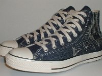 Blue Denim Embroidered High Top Chucks  Angled side view of blue denim high tops with stitched details.