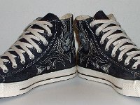 Blue Denim Embroidered High Top Chucks  Angled front view of blue denim high tops with stitched details.