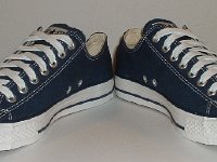 Blue Low Cut Chucks  Angled front view of navy blue low cut chucks.