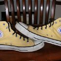Brad Deniston Collection of Chucks  Inside patch views of banana yellow high tops with narrow black shoelaces.