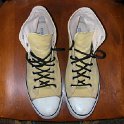 Brad Deniston Collection of Chucks  Top view of banana yellow high tops with narrow black shoelaces.