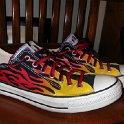 Brad Deniston Collection of Chucks  Side view of black flames low cut with chucks black and red reversible shoelaces.