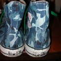 Brad Deniston Collection of Chucks  Rear view of blue camouflage high tops with green shoelaces.