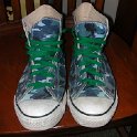 Brad Deniston Collection of Chucks  Top view of blue camouflage high tops with green shoelaces.