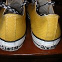Brad Deniston Collection of Chucks  Rear view of gold low cut chucks with black and white checkered laces.