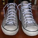 Brad Deniston Collection of Chucks  Front view of silver vinyl high tops.