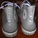 Brad Deniston Collection of Chucks  Reart view of silver vinyl high tops.
