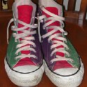 Brad Deniston Collection of Chucks  Front view of green, red and purple tricolor high tops.