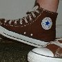 Brown High Top Chucks  Wearing chocolate high tops, left side view.