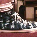 Camouflage Chucks  Wearing blue camouflage high tops, right side view.