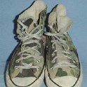 Camouflage Chucks  Worn green camouflage high tops, front view.