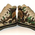 Camouflage Chucks  Angled front view of olive green camouflage high tops.
