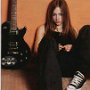 Celebrities Wearing Black Chucks  Avril Lavigne sitting with her black guitar.