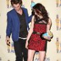 Celebrities Wearing Black Chucks  Actress Kristen Stewart and actor Robert Pattinson at the 18th Annual MTV Movie Awards, shot 2.