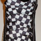 Black and White Checkered Shoelaces on Chucks  Black high top with black and white checkered shoelaces.