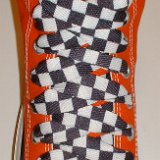 Black and White Checkered Shoelaces on Chucks  Orange high top with black and white checkered shoelaces.