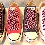 Black and Pink Checkered Shoelaces on Chucks  Core color low top chucks with black and pink checkered shoelaces.