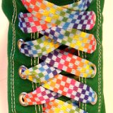 Rainbow Checkered Print Shoelaces On Chucks  Rainbow checkered print shoelace on a kelly green high top chuck.