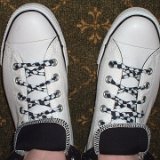Black and White Checkered Shoelaces on Chucks  Top view of white and black foldovers laced with rolled up black and white checkered shoelaces.