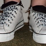 Black and White Checkered Shoelaces on Chucks  Front view of white and black foldovers laced with rolled up black and white checkered shoelaces.