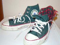 Christmas High Top Chucks  Angled side view of green and red 2 tone high tops showing the inside patch and plaid interior.
