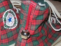 Christmas High Top Chucks  Closeup of the Converse holiday patch and jingle bell on a pair of plaid Christmas high tops.