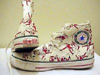 Christmas High Top Chucks  White "Santa skiing" high tops, showing inside right and rear heel patch views.