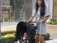 Ciara  Ciara taking a stroll with her baby in grey high top chucks.