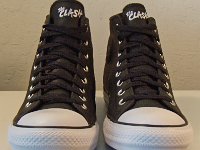 The Clash Black Leather High Top Chucks  Angled side view of Clash black leather high tops.