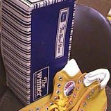 Collectors Items  Winner high tops with blue foxing and toecaps and yellow canvas uppers, angled side and top view with box.