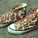 Collectors Items  Giraffe pattern high tops, angled side views.